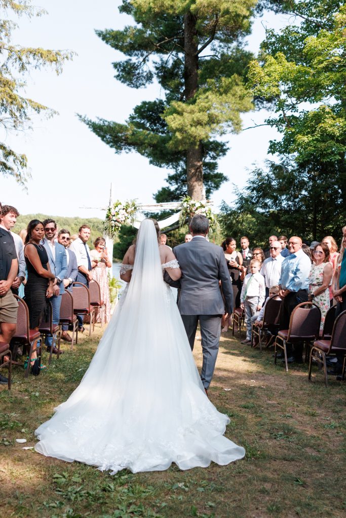 Bride and groom walking down the aisle at a Lakewoods Resort destination wedding in Cable