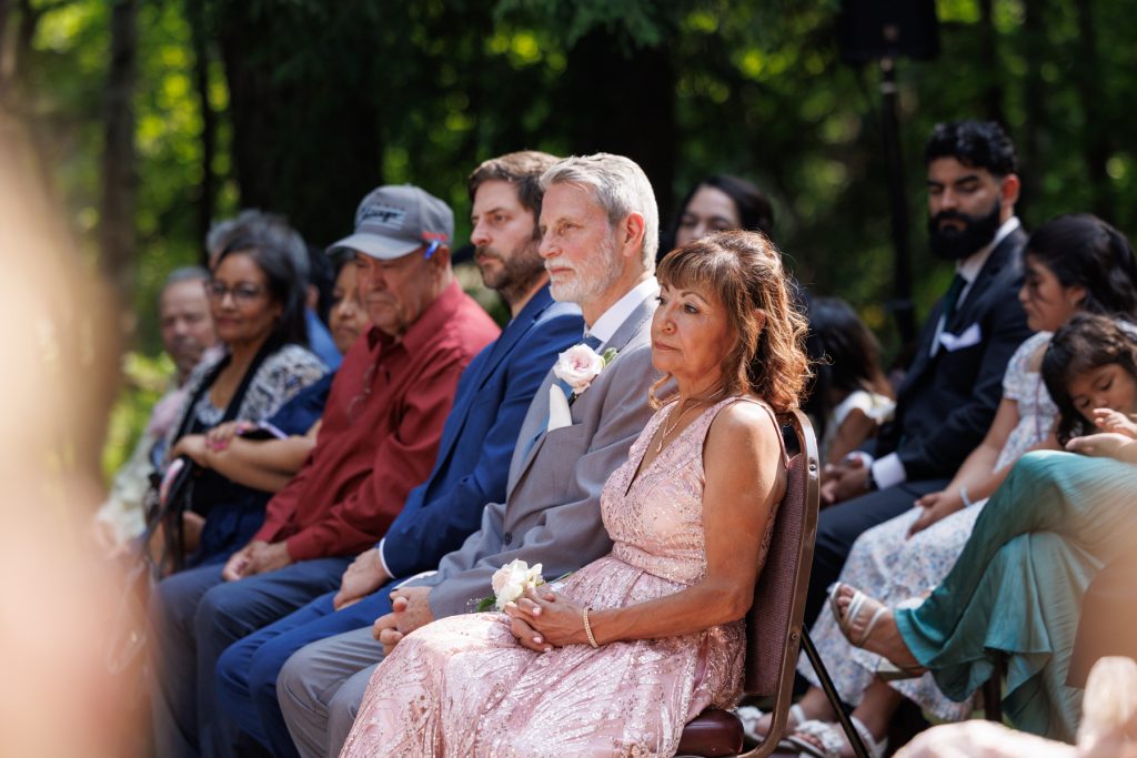Wedding guests seated during Bianca and Nick’s destination wedding at Lakewoods Resort in Cable, Wisconsin