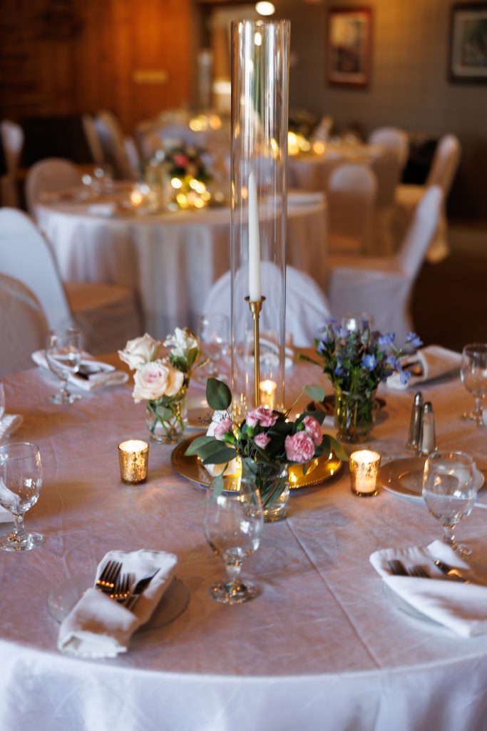 Elegant wedding table centerpiece with candles and floral arrangements at Lakewoods Resort in Cable, Wisconsin
