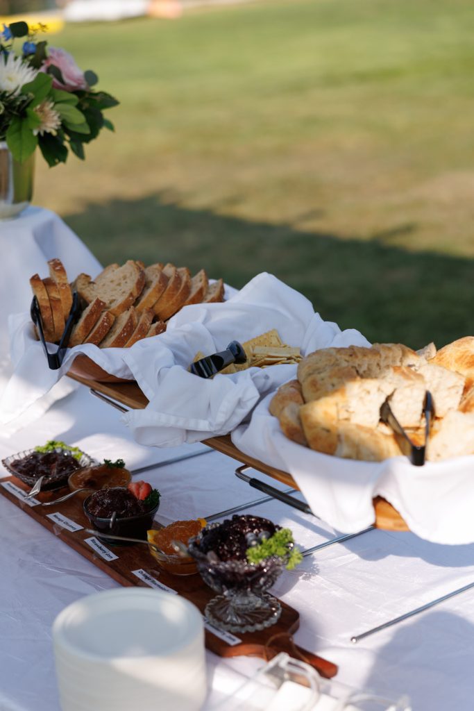 Beautifully arranged wedding reception spread with bread, fruit, and jams at a Lakewoods Resort wedding