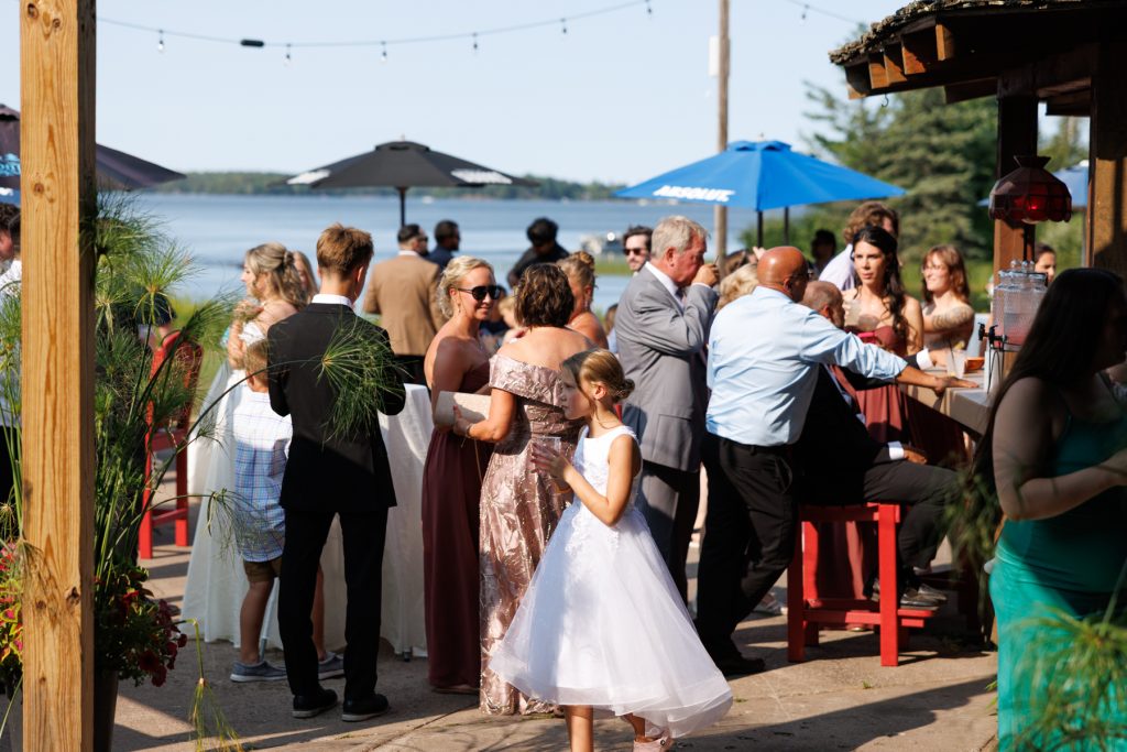Guests gathered at a Lakewoods Resort wedding reception on Lake Namekagon, enjoying drinks and conversation
