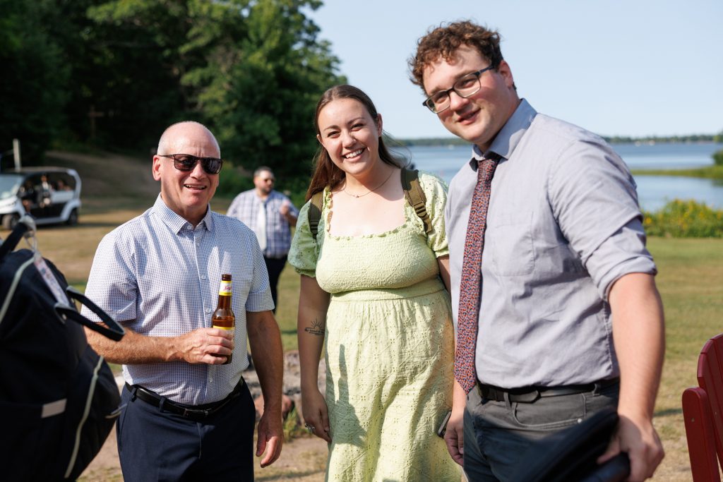 Three wedding guests smiling and posing for a photo at a Lakewoods Resort wedding