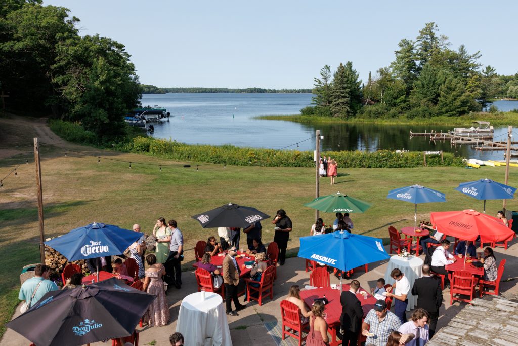 Guests mingle at a Lakewoods Resort wedding reception on Lake Namekagon, captured by Beau Petersen
