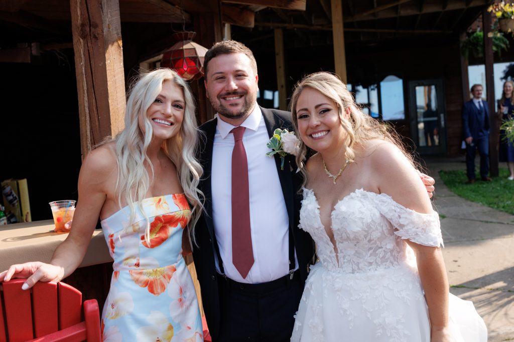 Bride and guests smiling for a portrait at a Lakewoods Resort wedding in Cable, Wisconsin