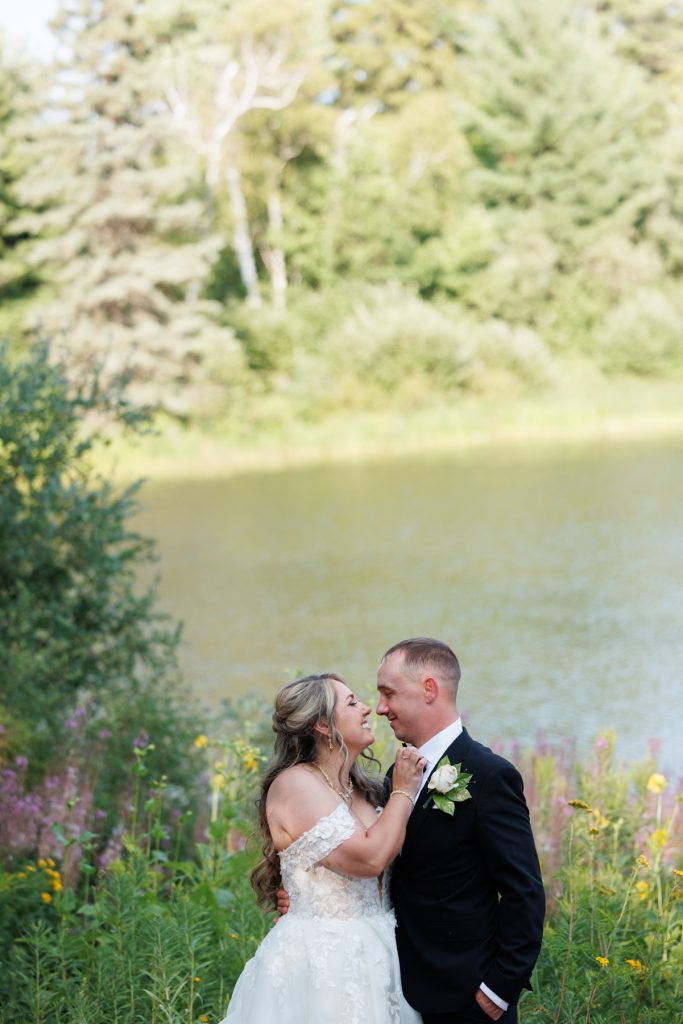 Bianca and Nick, the newly married couple, share a tender moment by Lake Namekagon