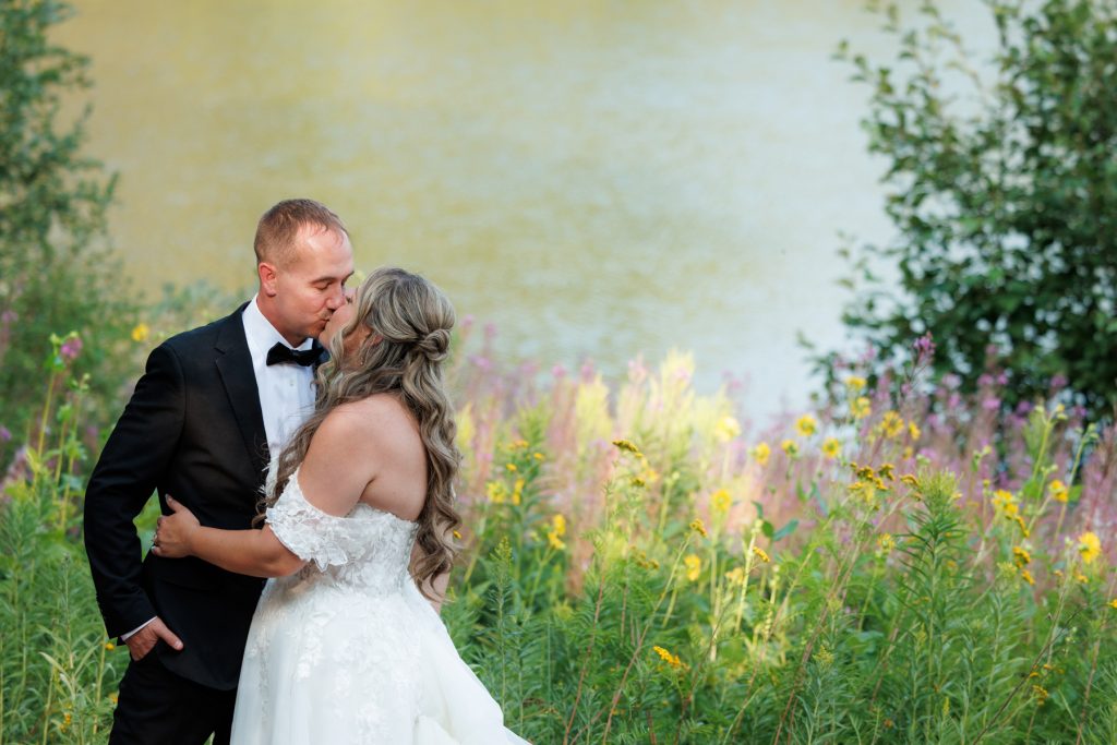 Bianca and Nick share a tender kiss during their destination wedding at Lakewoods Resort