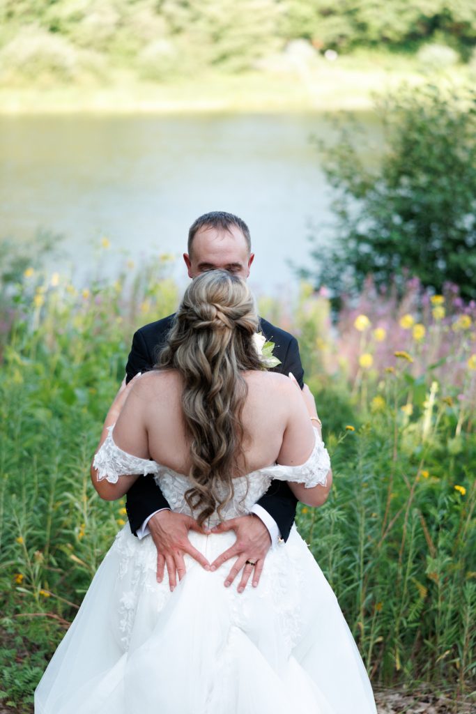 Bride and groom embrace during their destination wedding at Lakewoods Resort on Lake Namekagon, captured