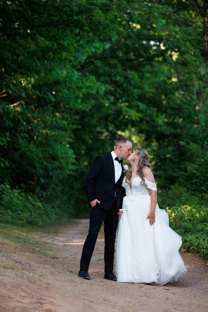 Bianca and Nick share a tender kiss during their destination wedding at Lakewoods Resort