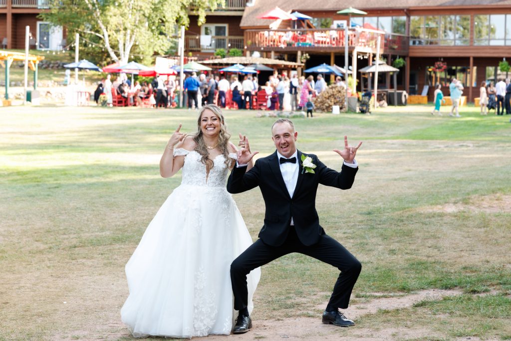 Bride and groom, Bianca and Nick, playfully pose at their Lakewoods Resort wedding in Cable