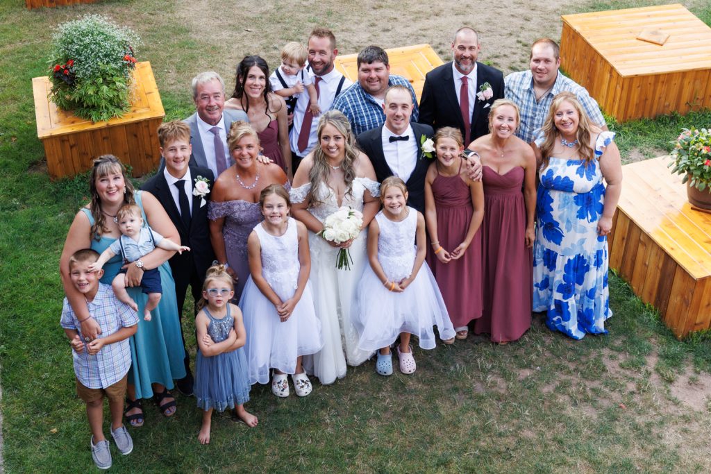 Bianca and Nick, the newlyweds, pose with family and wedding party at their Lakewoods Resort