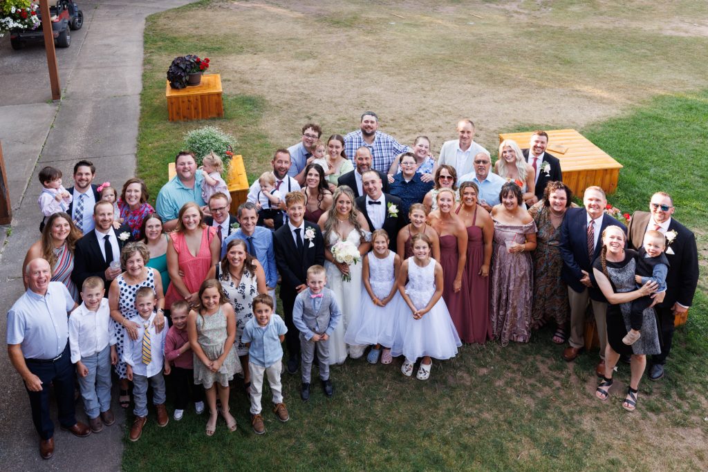 Large group wedding portrait of Bianca and Nick at Lakewoods Resort in Cable, Wisconsin, surrounded