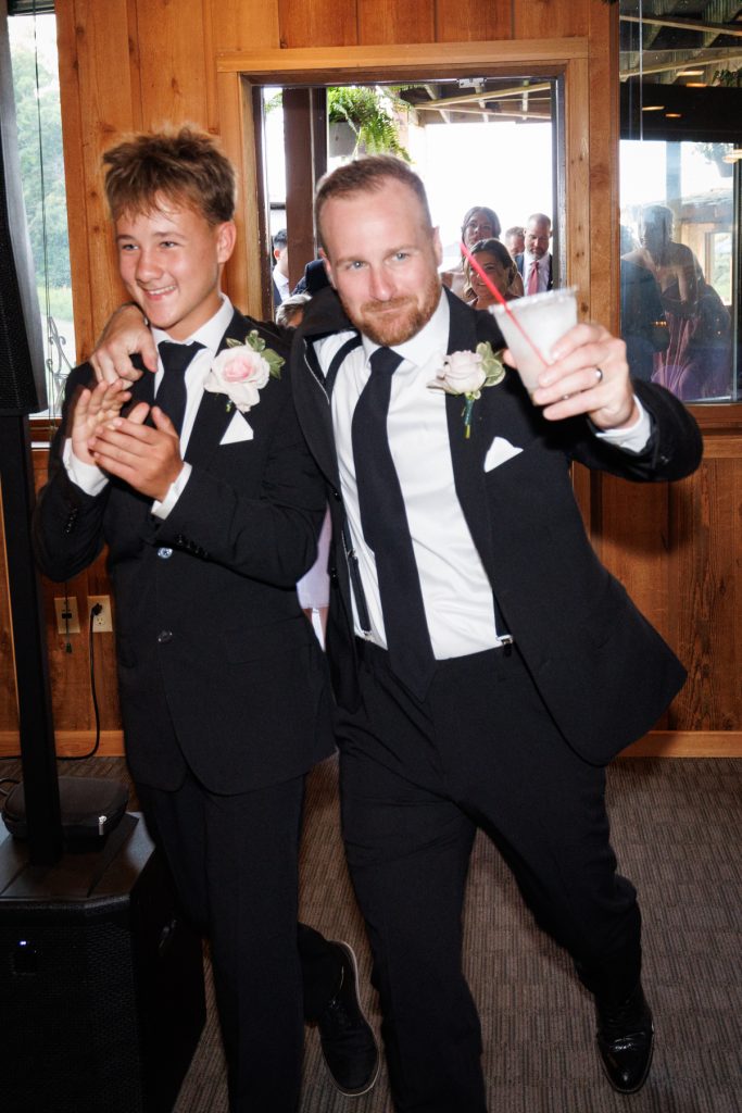 Groom and groomsman celebrating at a Lakewoods Resort wedding in Cable, Wisconsin, captured by Beau
