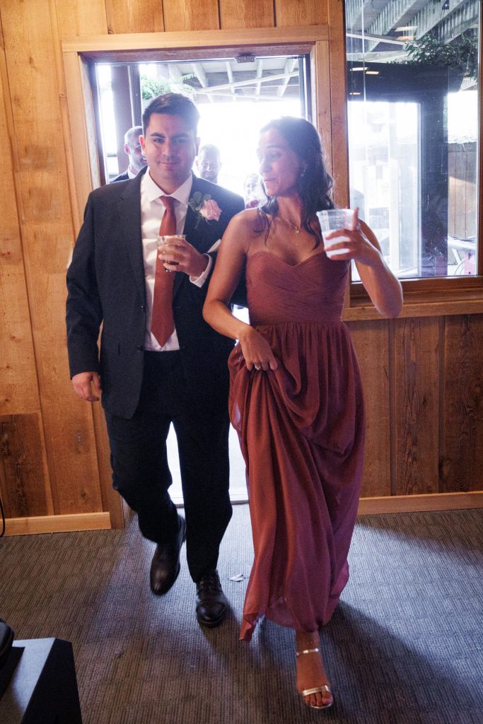 Bianca and Nick, the Lakewoods Resort wedding couple, exit through a doorway, celebrating their special