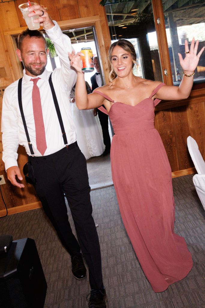 Bianca and Nick, the Lakewoods Resort wedding couple, joyfully enter the reception hall, celebrating