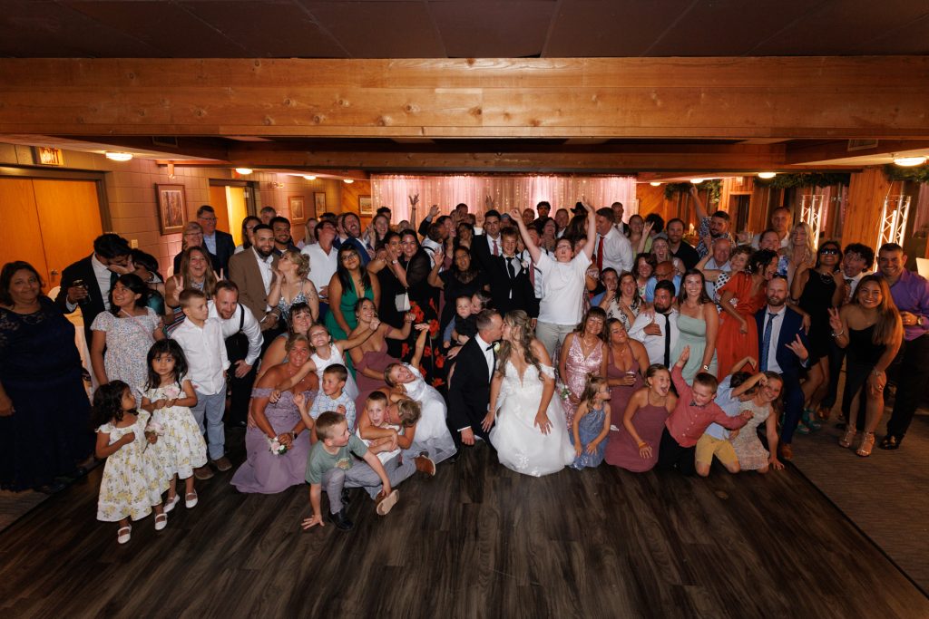 Large group wedding photograph featuring Bianca and Nick at Lakewoods Resort in Cable, Wisconsin, captured