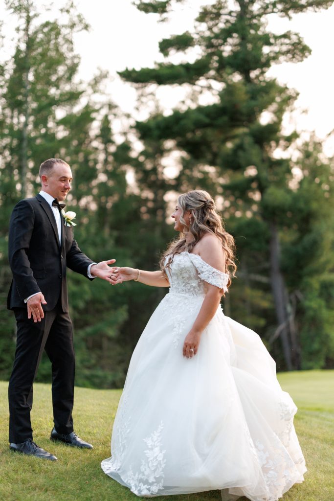 Bianca and Nick, the happy couple, holding hands during their destination wedding at Lakewoods Resort