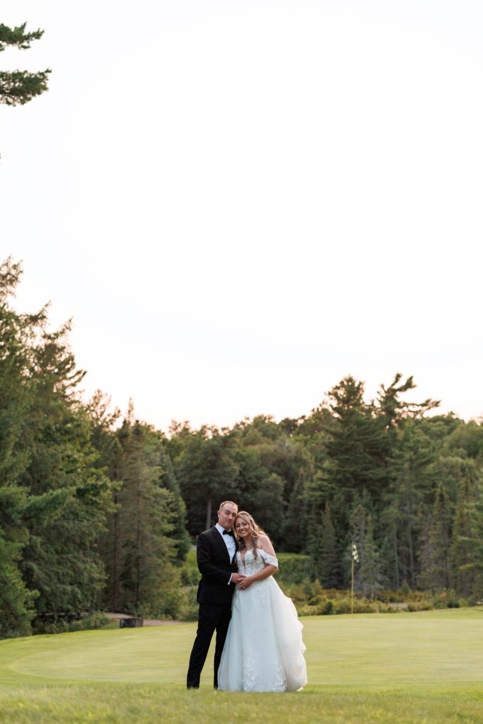 Bianca and Nick, the newlyweds, share a tender moment captured by Beau Petersen Photography
