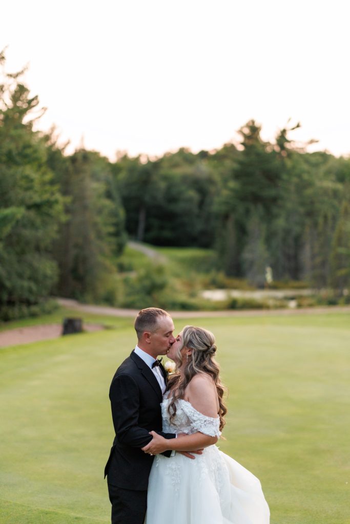 Bianca and Nick share a romantic kiss during their Lakewoods Resort wedding in Cable, Wisconsin