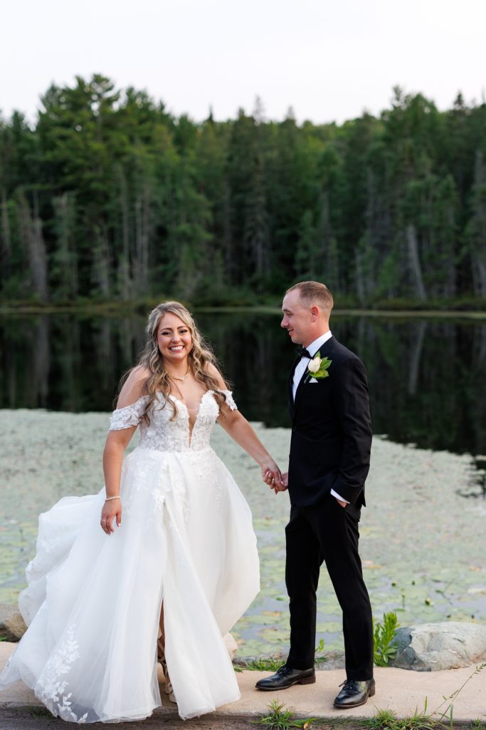 Bianca and Nick, the happy couple, hold hands and smile during their Lakewoods Resort wedding
