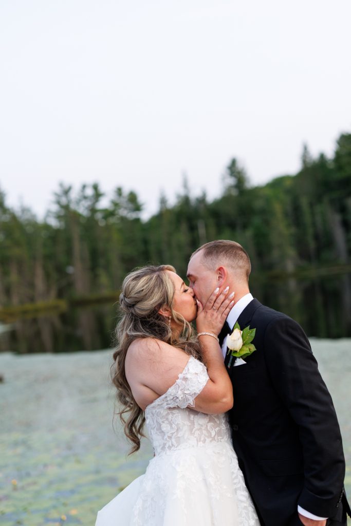 Bianca and Nick share a tender kiss during their destination wedding at Lakewoods Resort