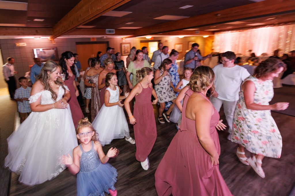 Guests celebrating at a wedding reception at Lakewoods Resort in Cable, Wisconsin, captured by Beau