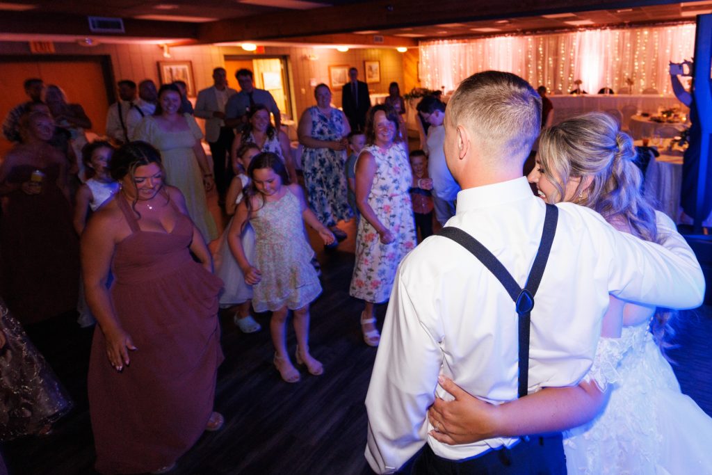 Bianca and Nick share a joyful dance with guests at their Lakewoods Resort wedding