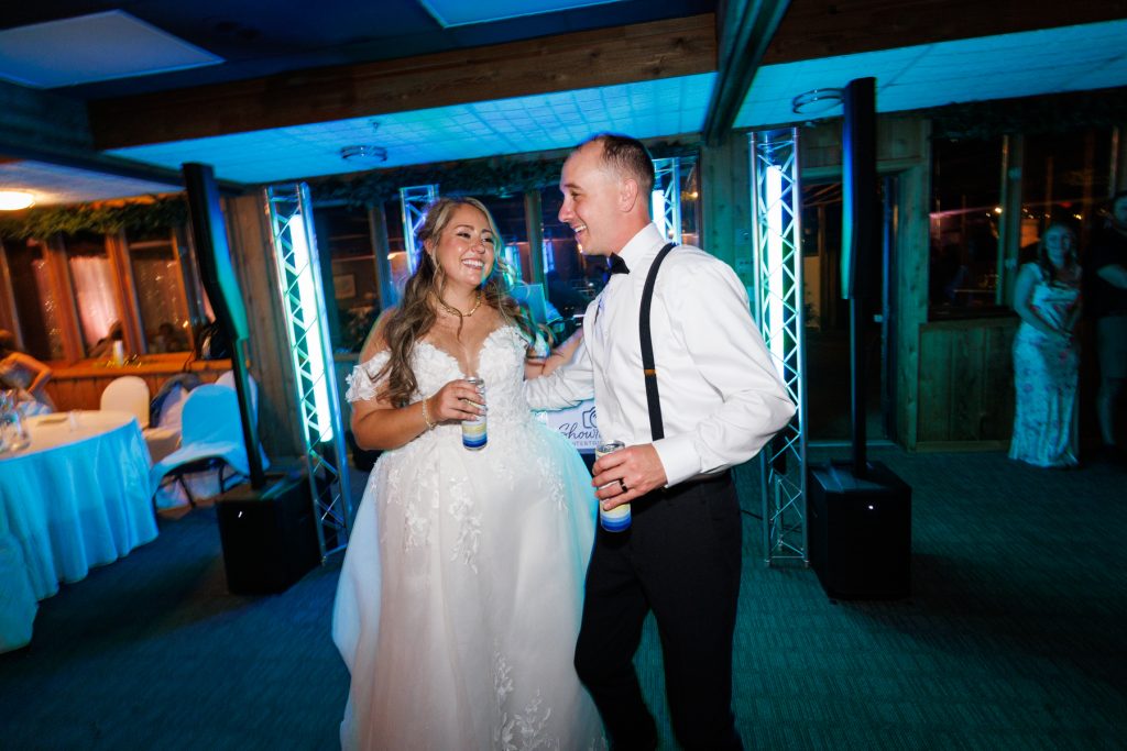Bianca and Nick, the newlyweds, joyfully dance at their Lakewoods Resort wedding reception in Cable