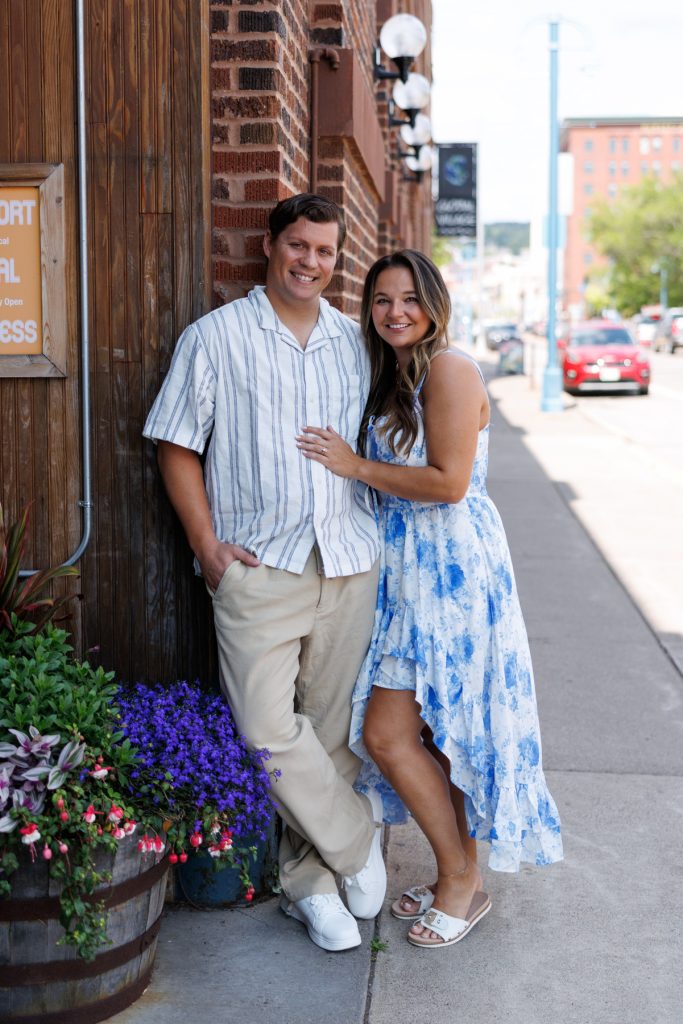 Cassie and Daniel, the engaged couple, smile warmly during their Duluth and Bayfield engagement session