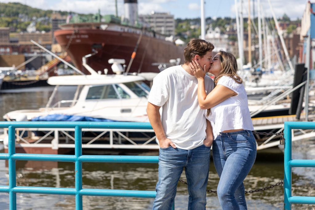 Cassie and Daniel share a romantic kiss during their engagement session near the Duluth harbor