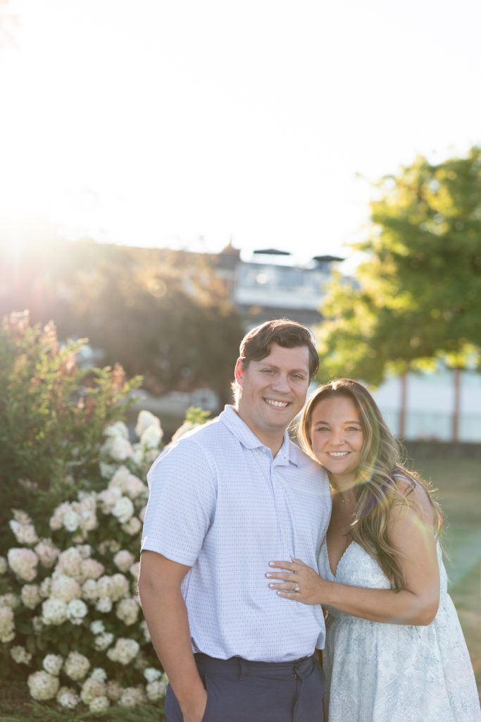 Cassie and Daniel, the engaged couple, smiling warmly during their Lake Superior engagement session