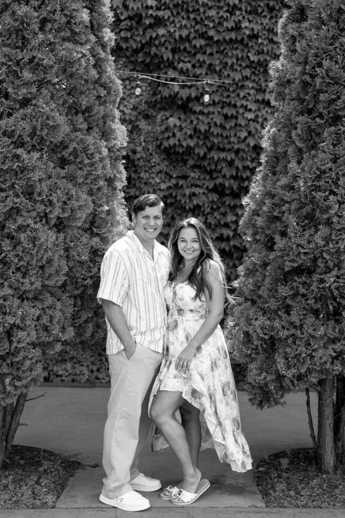 Cassie and Daniel, the engaged couple, smiling warmly during their Lake Superior engagement session
