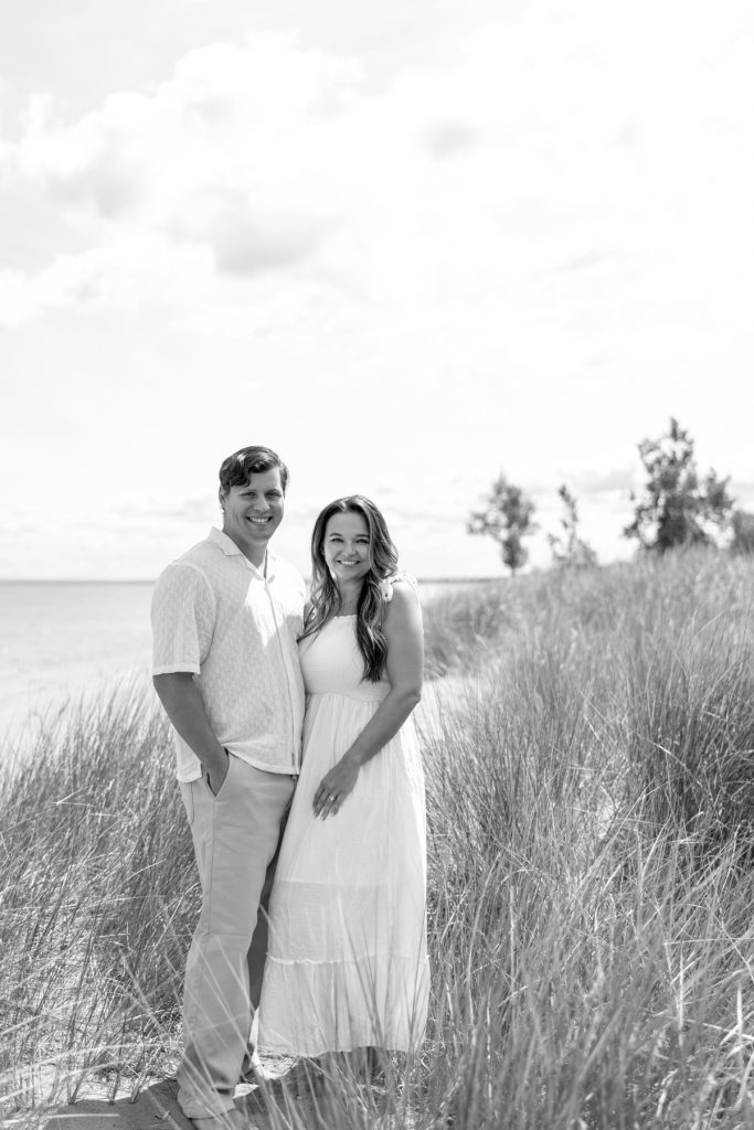 Cassie and Daniel, the engaged couple, smile warmly during their Lake Superior engagement session