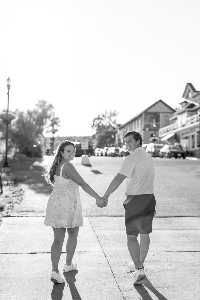Cassie and Daniel, engaged couple, holding hands and walking away from the camera in Duluth