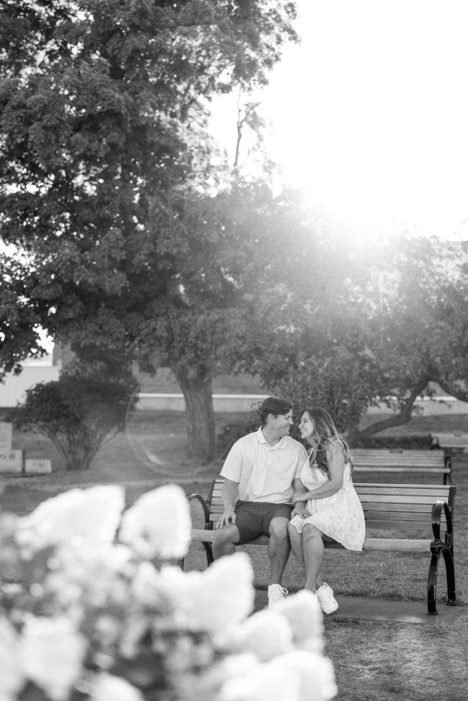 Cassie and Daniel share a tender moment on a park bench during their engagement session
